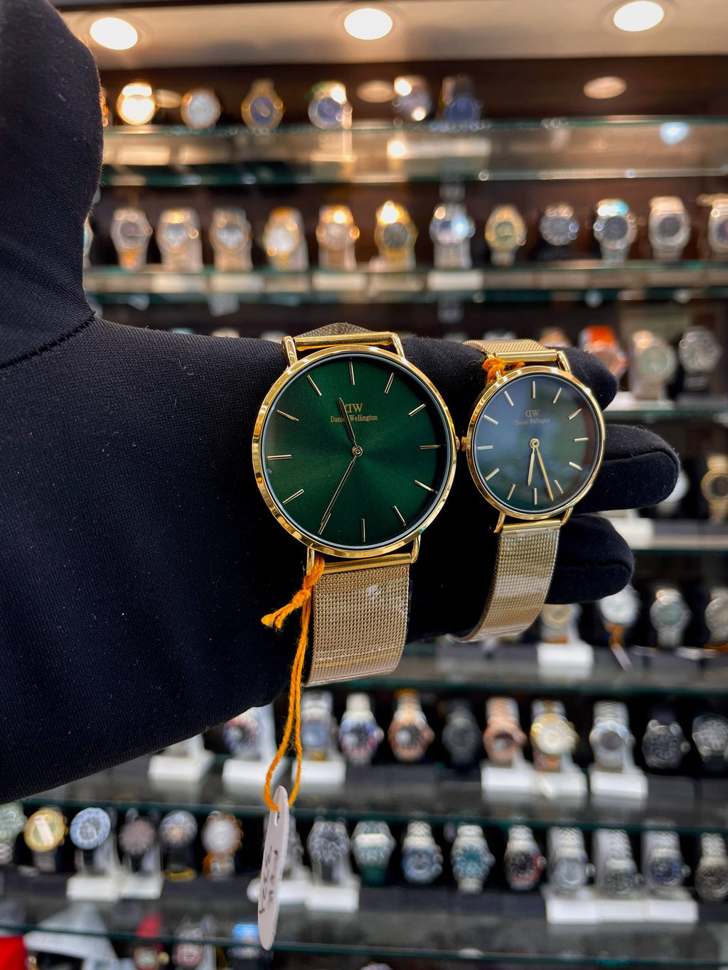 Daniel Wellington gold chain matching watches angled view