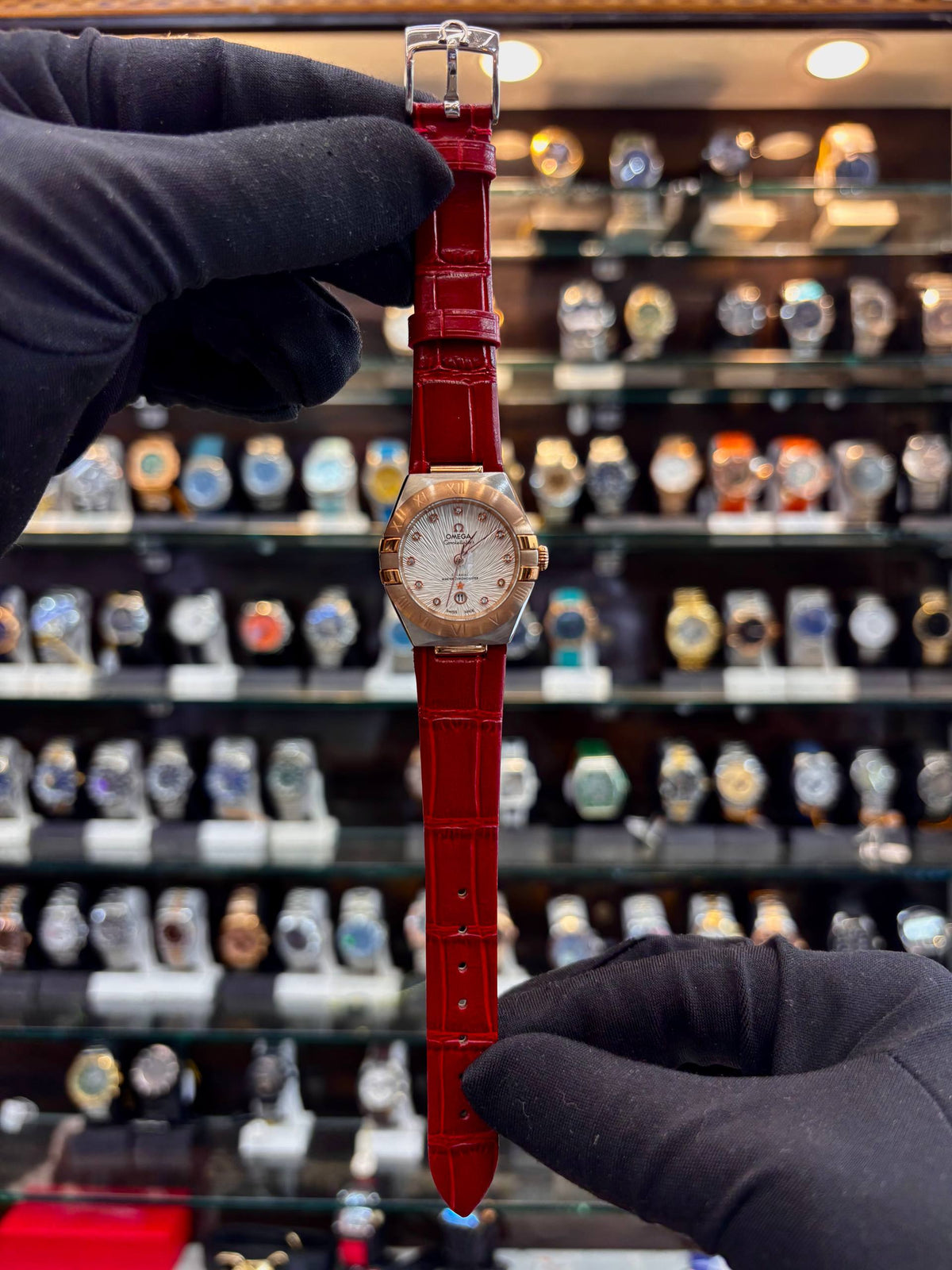 Omega Constellation red strap luxury watch front view