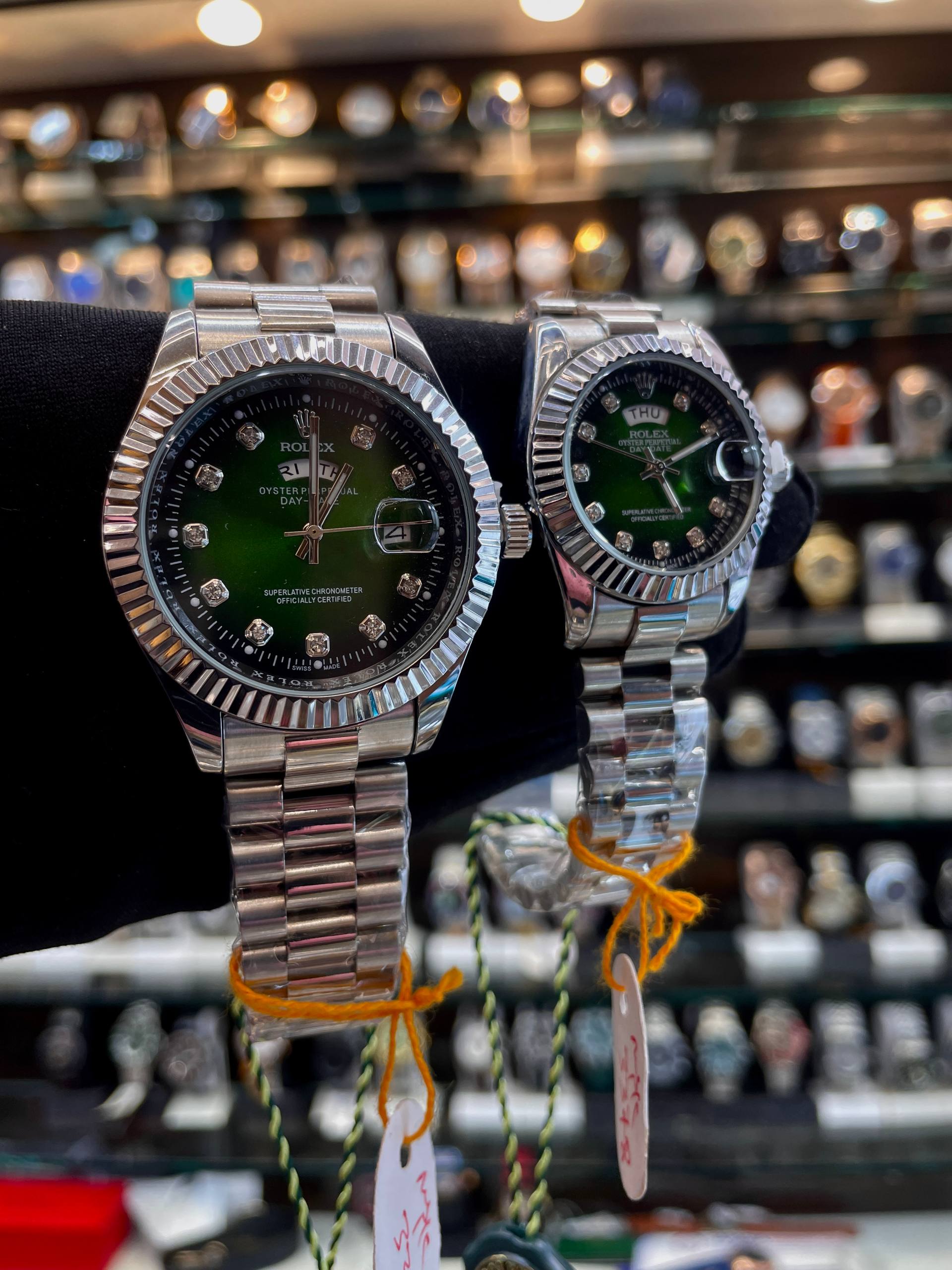Green diamond dial matching couple watches side view
