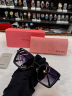 Miu Miu girls black sunglasses frame detail