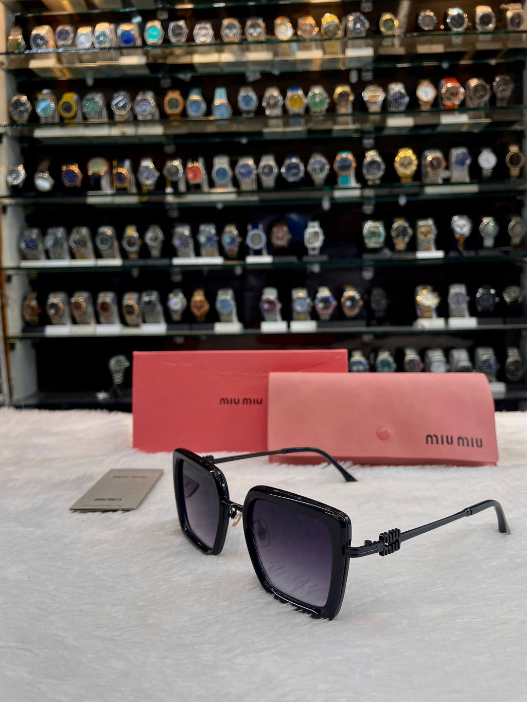 Miu Miu oversized black sunglasses angled view
