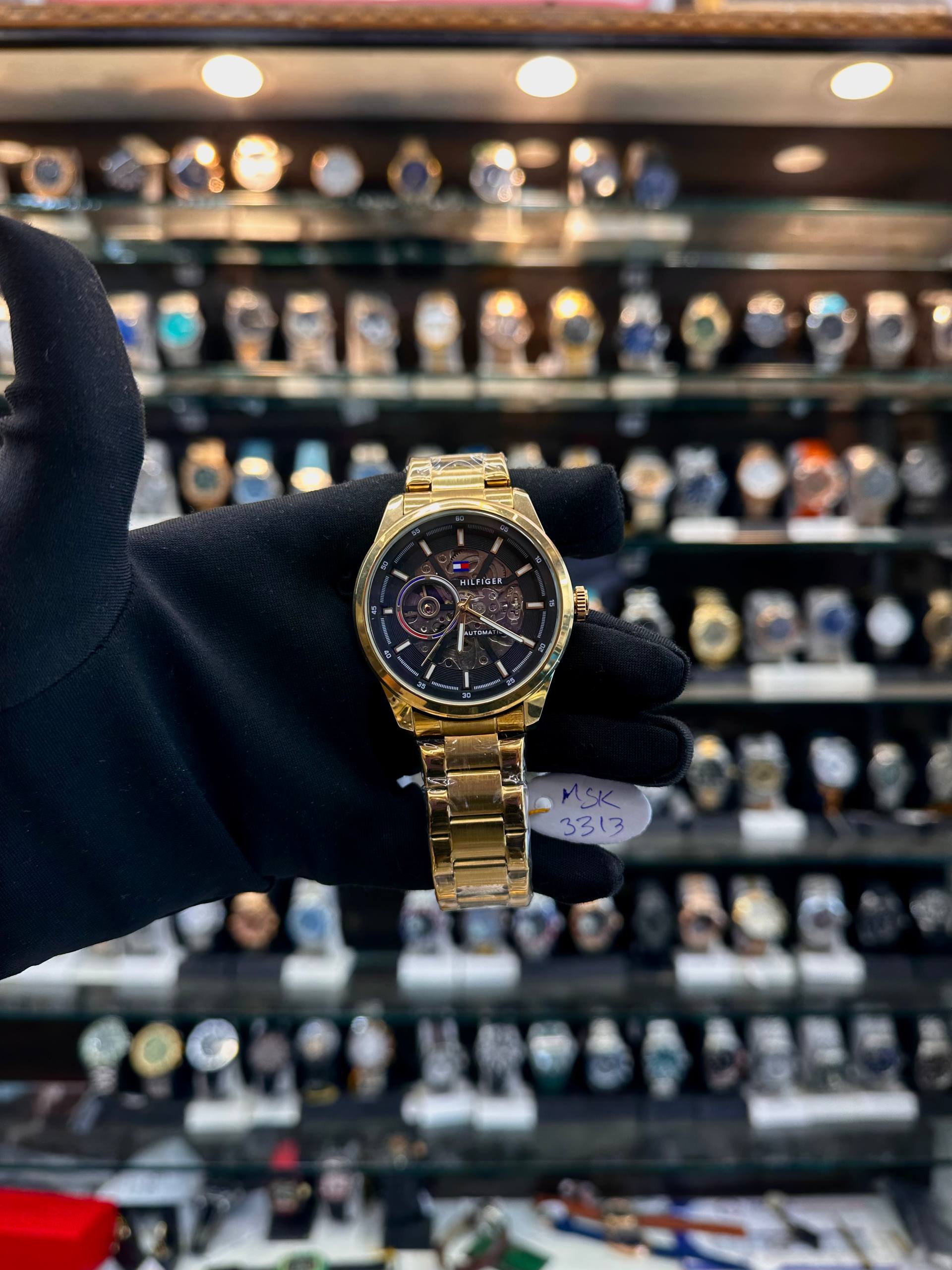 Tommy Hilfiger automatic gold chain watch front view